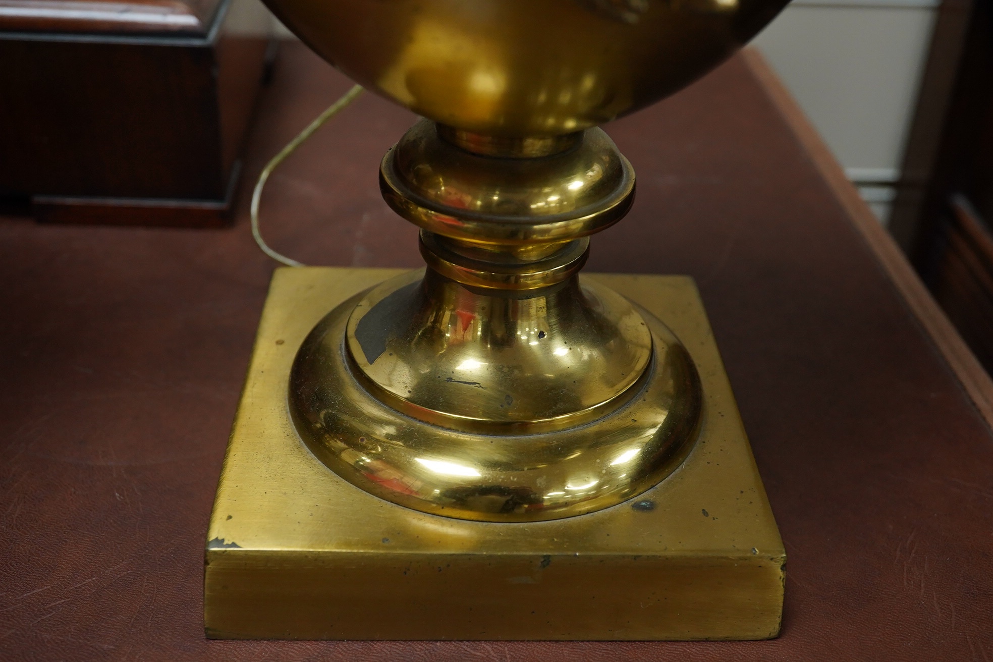 A pair of Empire style brass lamps with twin handles and applied decoration, 36cm high including the fitting. Condition - fair to good, untested